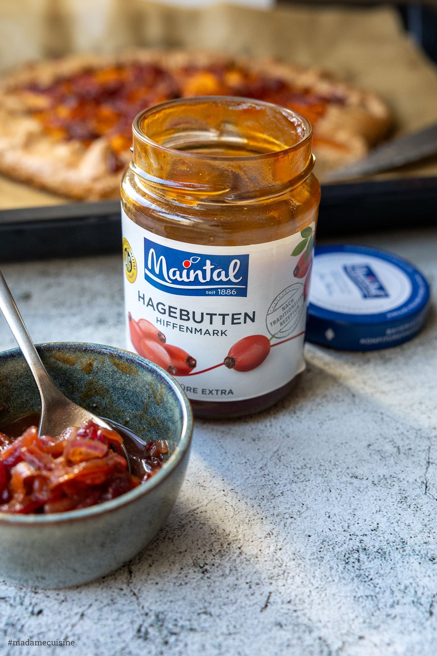Maintal Hagebutten-Konfitüre und Zwiebel-Chutney im Schälchen, Süßkartoffel-Galette im Hintergrund